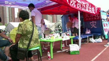 Explosions en Chine: des déplacés logent dans des tentes