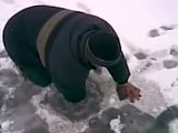 Russian man catches a big fish with bare hands from an ice hole