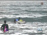 Bimby rides waves with champion surfer