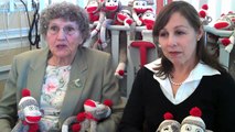 Volunteers deliver sock monkey toys to kids at Packard Children's