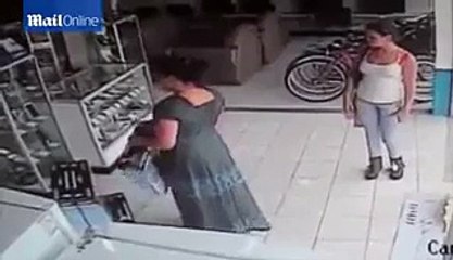 CCTV captures woman stuffing a plasma TV up her skirt -