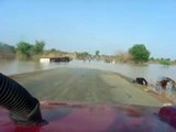 Driving by destroyed trucks and over flooded roads in Niger