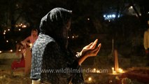 Muslim woman praying at graveyard during Shab-e-barat