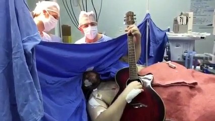 A man plays guitar during brain surgery