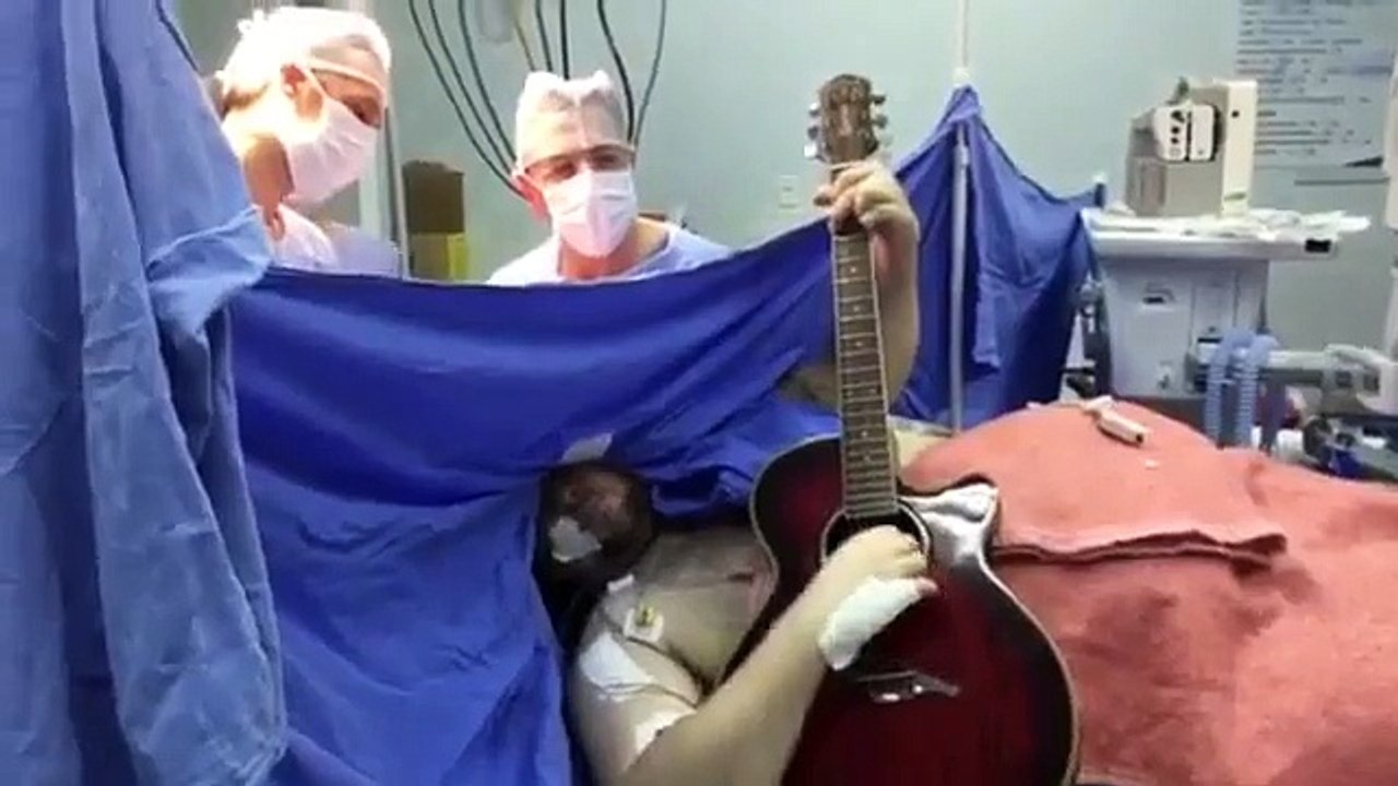 A man plays guitar during brain surgery