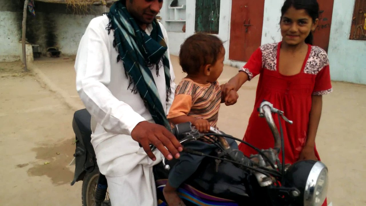 child want to sit on bike very funny child and very clever