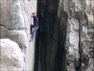 Il escalade une paroi sans protection... Dangereux!