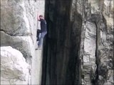 Crazy guy climbing a cliff without rope