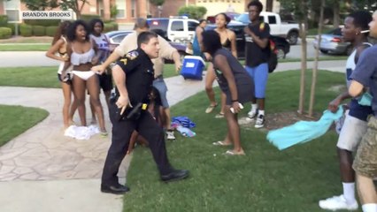 Watch Texas police officer pull gun on teens at pool party