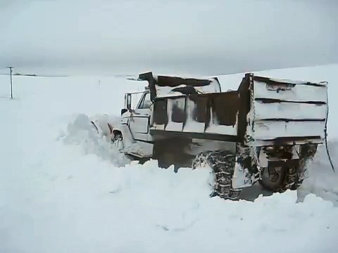 Large truck plowing snow blocked road - long version