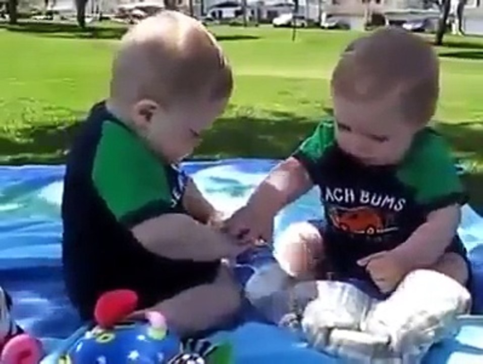 2 Babies Fighting Over Bottle