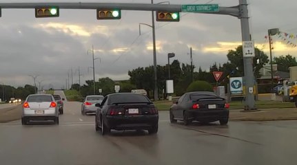 Mustang attempts street race in rain, crashes into light pole