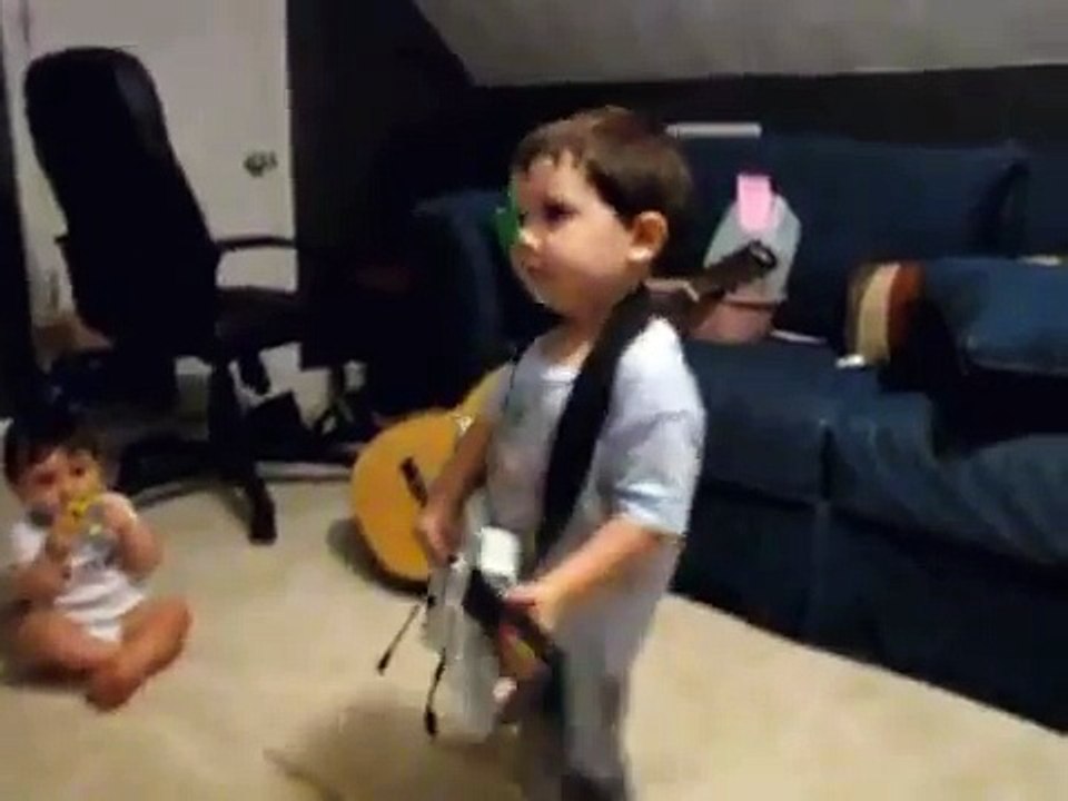 2 year old playing Bulls on Parade on Guitar Hero.....the music takes over.