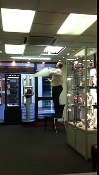 Fat optician changing a light bulb