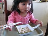 Two year old girl Kaitlyn eating pho with chopsticks and chinese spoon