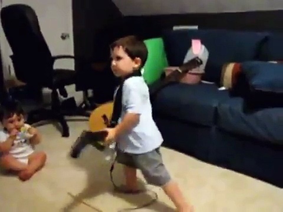 2 year old playing Bulls on Parade on Guitar Hero.....the music takes over.