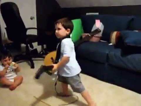 2 year old playing Bulls on Parade on Guitar Hero.....the music takes over.