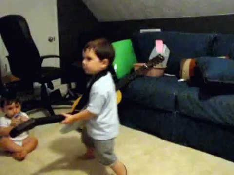 2 year old playing Bulls on Parade on Guitar Hero.....the music takes over.