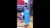 Une petite fille frappée par un soldat devant la reine d'Angleterre
