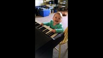 Baby extremely amused by piano playing