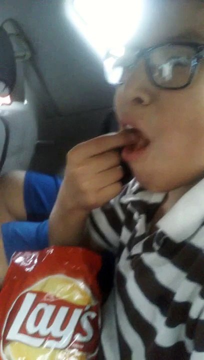 A cool guy eating chips