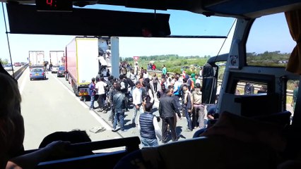 Rioting migrants trying to hide into trucks from Calais to Dover port