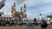 Young boy feeds pigeons at Charminar, Hyderabad