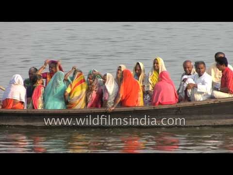 Indian devotees take boat ride on the holy Ganges River - Varanasi