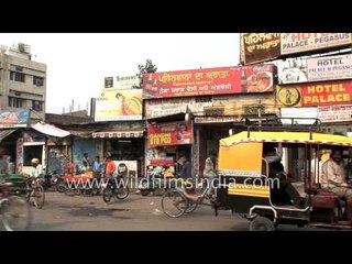 Pedestrians cross a congested street in Amritsar, Punjab
