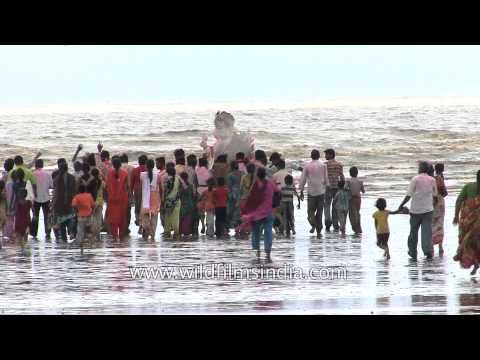 Devotees immersing idol of Lord Ganesha at a beach in Alang, Gujarat
