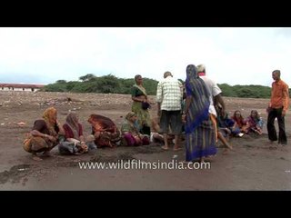 Devotees offer prayer and perform rituals at a beach in Alang, Gujarat