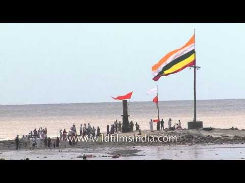 Devotees take holy water from priest at Alang beach in Gujarat