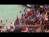 Hindu devotees perform ritualistic bathing on the banks of river Ganges