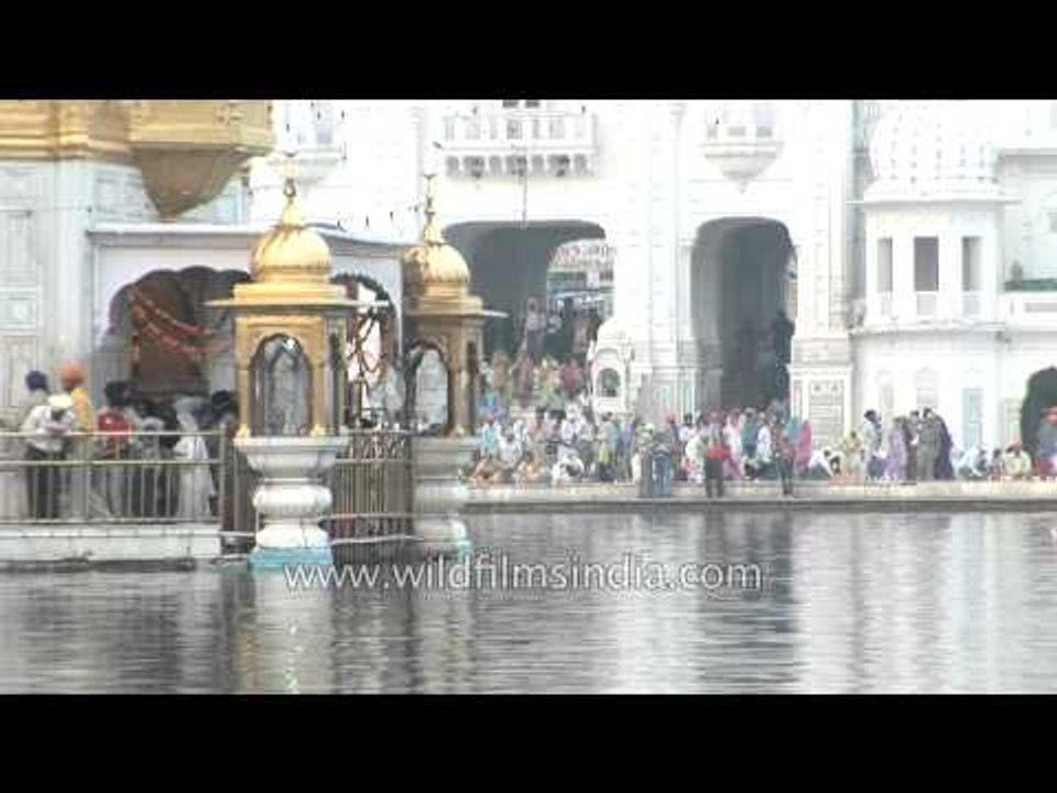 Sikh devotees light candles at the holy Sikh shrine of Golden Temple, Punjab
