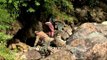 Fly fisherman walks down on slippery rocks for trout fishing - Kashmir