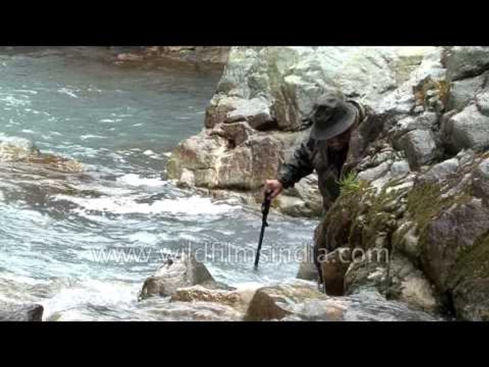 Angler with equipment and tackle prepare for trout fishing in Kashmir