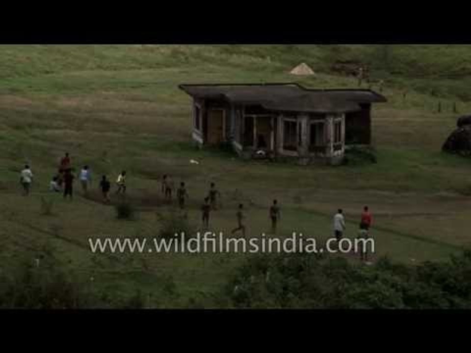 South Indian boys play soccer in lush green field - Munnar, Kerala