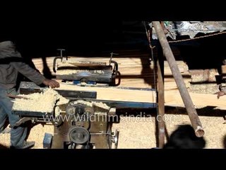 Carpenters prepare pine planks to build Himalayan home