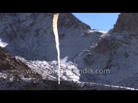 Prayer flags and wheel send Buddhist prayers across the mountains of Ladakh