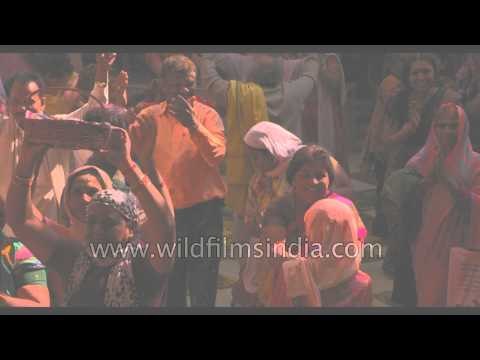 People throw coloured powder during Holi celebration - India