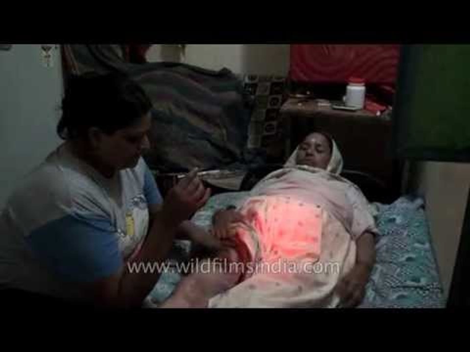 Indian hijra injects insulin into her mother's thigh