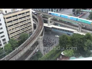 Sky trains whiz past the complex and layered Asian cityscape of Bangkok