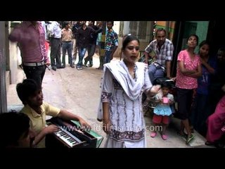 Indian eunuch dancing on a street in Delhi