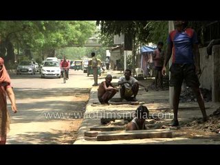 Workers cleaning drain in India