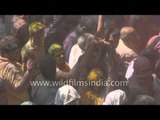 Woman smeared in colours dancing with great zeal at Banke Bihari Temple