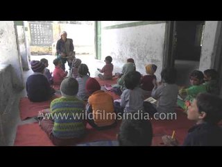 Girls and boys learn school rhymes in a remote Himalayan village