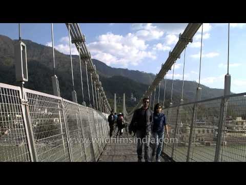 People cross the Sivananda bridge or Ram jhula, Rishikesh