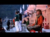 A foreigner lady meditates on the banks of River Ganga - Rishikesh