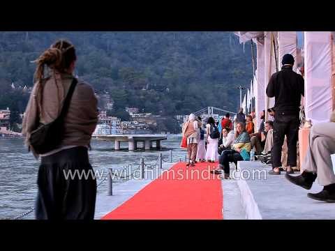 People relax on the banks of the Ganga river in Rishikesh