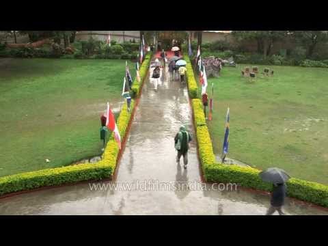 Rainy day in Rishikesh: yoga guests brave rain with umbrellas